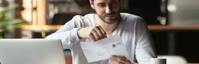 A man opening an envelope